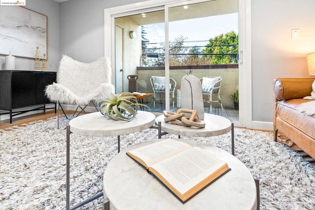 living area with hardwood / wood-style flooring