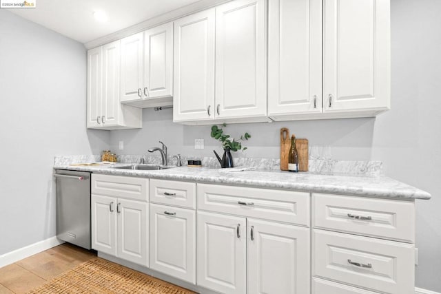 kitchen featuring light wood-type flooring, white cabinetry, dishwasher, and sink