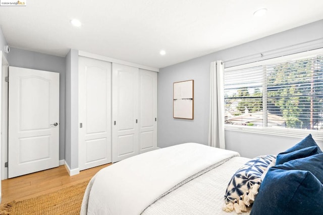 bedroom featuring a closet and light wood-type flooring