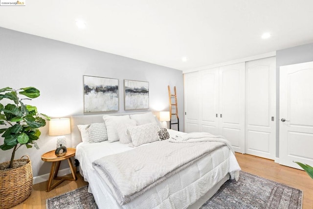 bedroom with light wood-type flooring and a closet