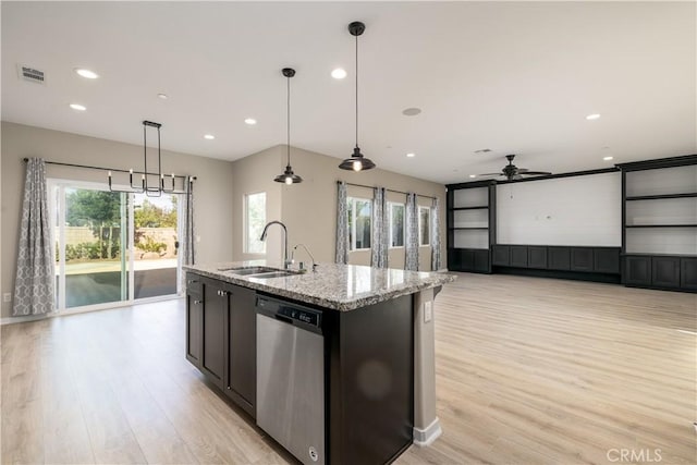 kitchen with a wealth of natural light, dishwasher, pendant lighting, and sink