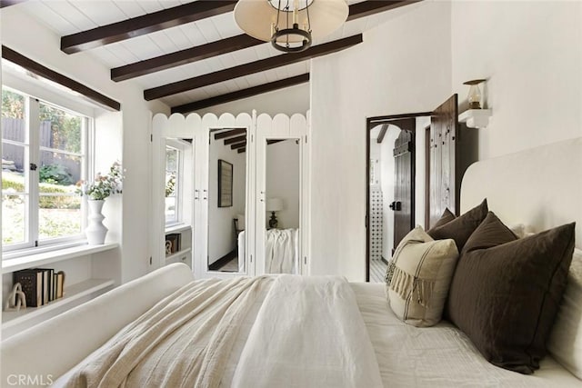 bedroom featuring lofted ceiling with beams, a notable chandelier, and wood ceiling