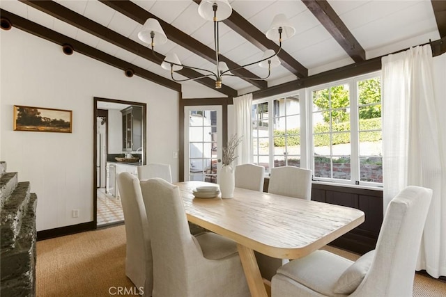 dining space with vaulted ceiling with beams, light carpet, and plenty of natural light