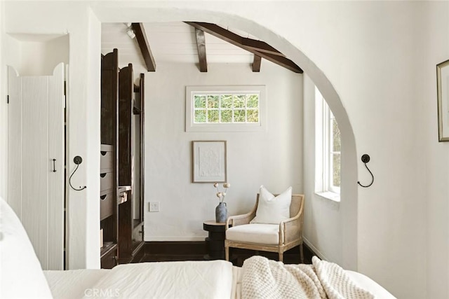 bedroom with lofted ceiling with beams, dark hardwood / wood-style floors, and wooden ceiling