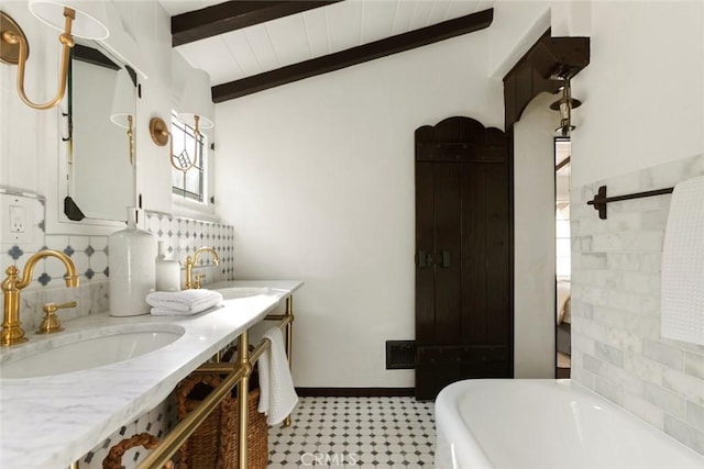 bathroom featuring vaulted ceiling with beams, a bathtub, vanity, and wood ceiling