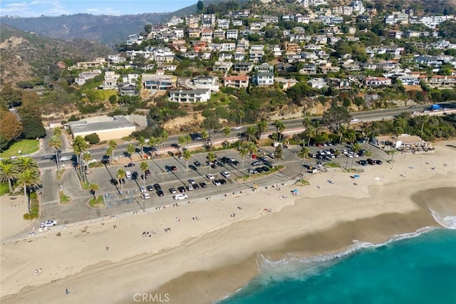 birds eye view of property featuring a view of the beach and a water view