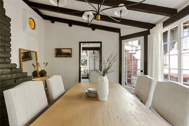 dining space with vaulted ceiling with beams and wood-type flooring