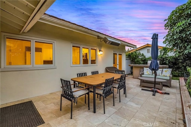 patio terrace at dusk featuring outdoor lounge area