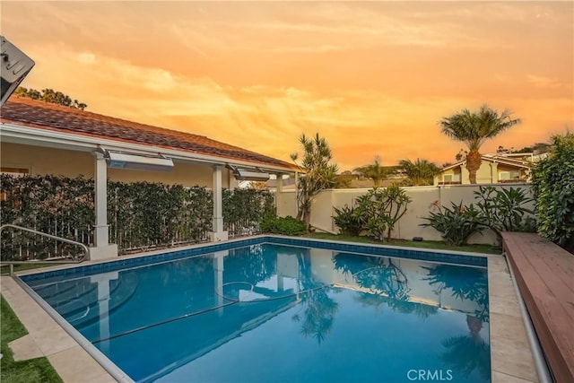 view of pool at dusk