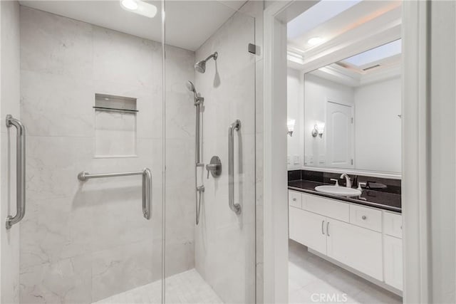 bathroom with vanity and a shower with door