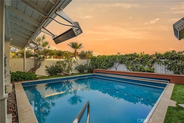 view of pool at dusk