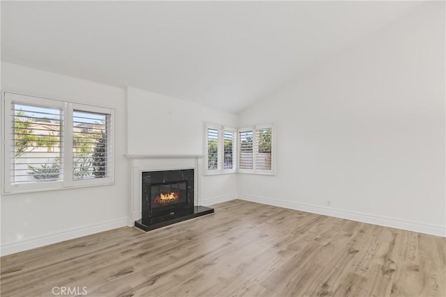 unfurnished living room featuring light hardwood / wood-style floors and vaulted ceiling