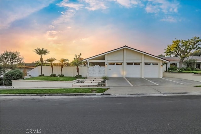 view of front of home with a yard and a garage