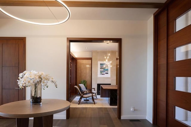 hall featuring dark hardwood / wood-style flooring and an inviting chandelier