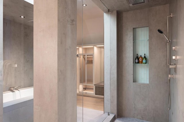 interior space with vanity and a shower