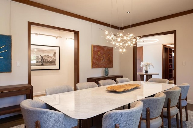 dining area featuring wood-type flooring, crown molding, and a notable chandelier