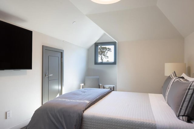 bedroom featuring lofted ceiling