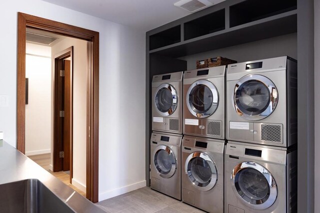 clothes washing area with stacked washer / dryer and washing machine and clothes dryer