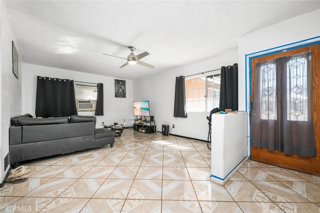 tiled foyer entrance with a textured ceiling, ceiling fan, and cooling unit