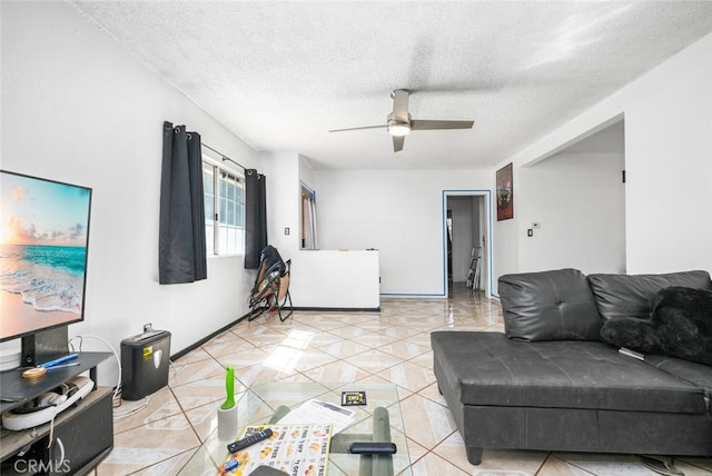 tiled living room featuring ceiling fan and a textured ceiling