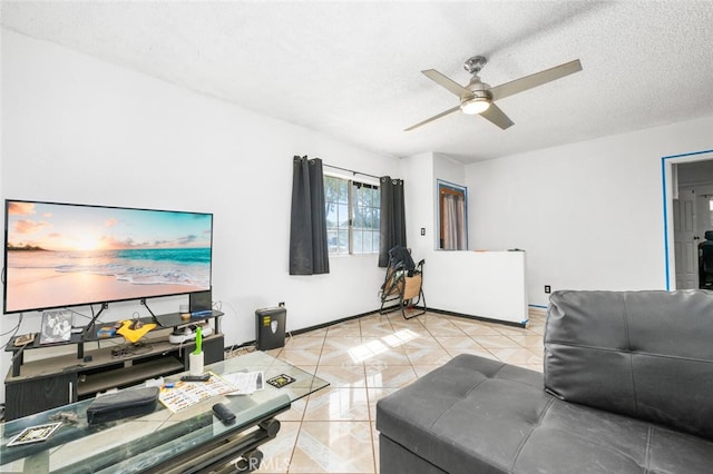 tiled living room with ceiling fan and a textured ceiling