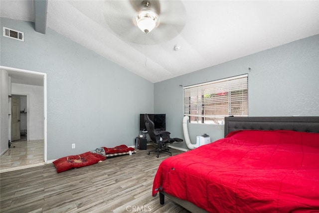 bedroom featuring lofted ceiling with beams, ceiling fan, and wood-type flooring