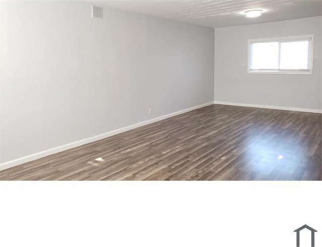 empty room with dark hardwood / wood-style floors