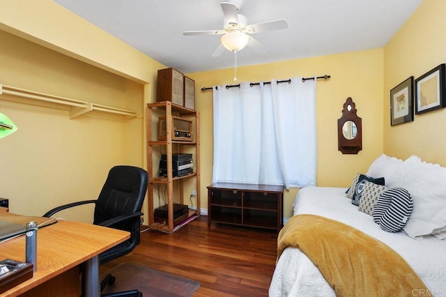 bedroom with dark hardwood / wood-style flooring, a closet, and ceiling fan