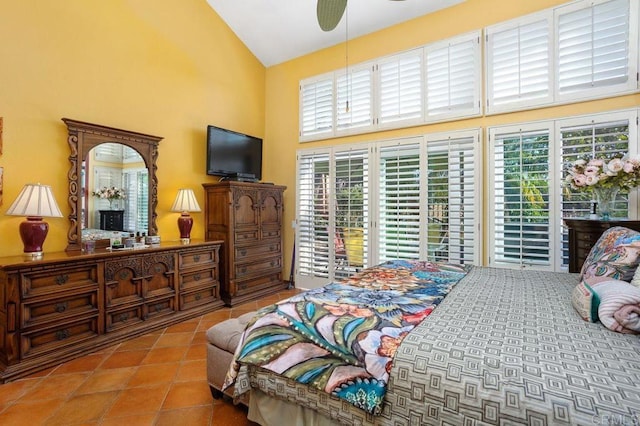 bedroom featuring ceiling fan, a towering ceiling, access to outside, and multiple windows