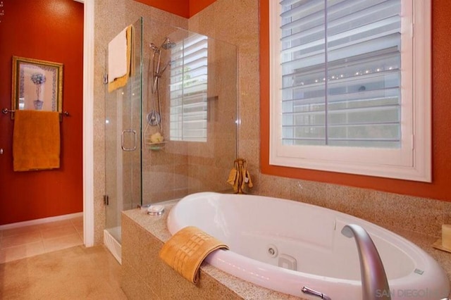 bathroom featuring tile patterned floors and separate shower and tub