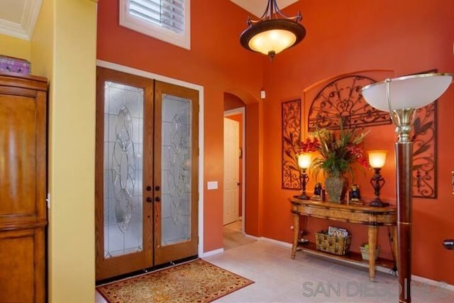 entrance foyer featuring ornamental molding and french doors