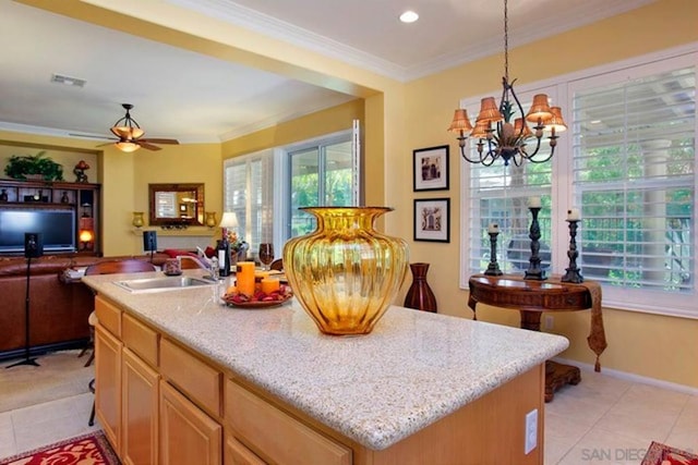 kitchen featuring crown molding, a kitchen island with sink, pendant lighting, and light tile patterned floors