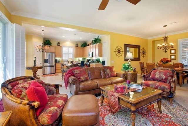 living room featuring crown molding and ceiling fan with notable chandelier