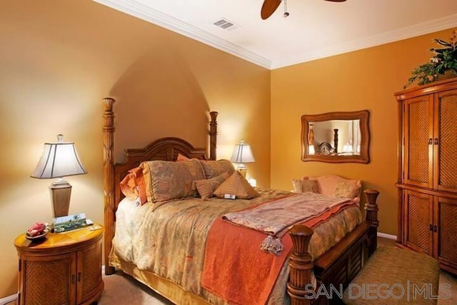 carpeted bedroom featuring ceiling fan and crown molding