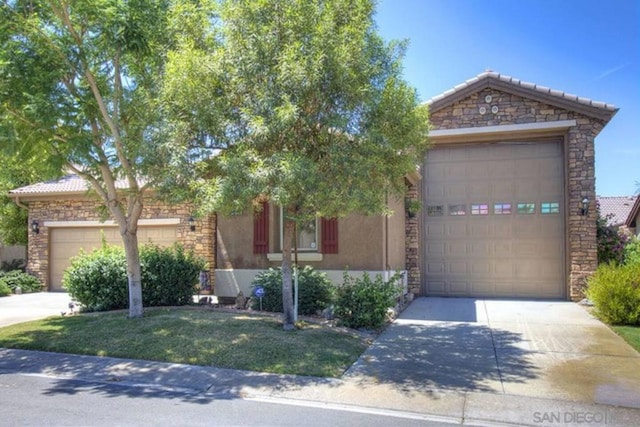 view of front of home with a front lawn and a garage