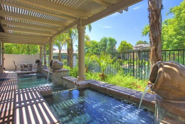 view of swimming pool with a patio and pool water feature