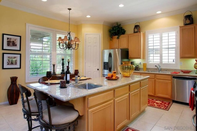 kitchen featuring appliances with stainless steel finishes, sink, pendant lighting, an inviting chandelier, and a kitchen island with sink