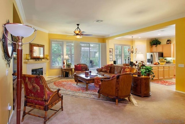 carpeted living room with crown molding, a tile fireplace, and ceiling fan with notable chandelier