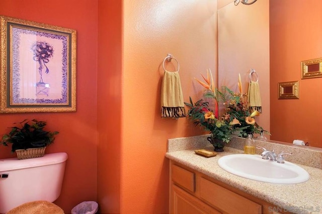 bathroom featuring toilet and vanity