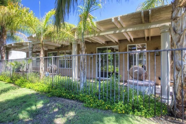 exterior space with a yard and a pergola