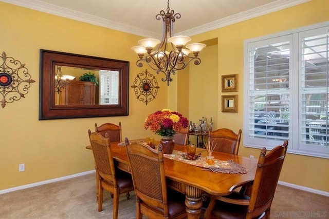 dining room with crown molding, a chandelier, and light colored carpet