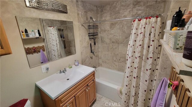 bathroom featuring vanity and shower / bath combination with curtain