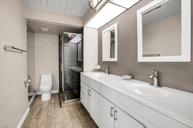 bathroom with hardwood / wood-style floors, vanity, toilet, and a shower with door