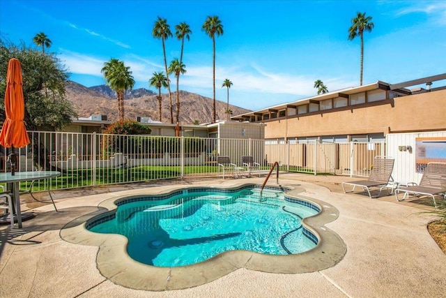 view of pool featuring a mountain view and a patio