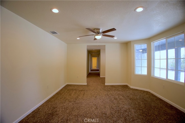 unfurnished room featuring ceiling fan, carpet flooring, and a textured ceiling