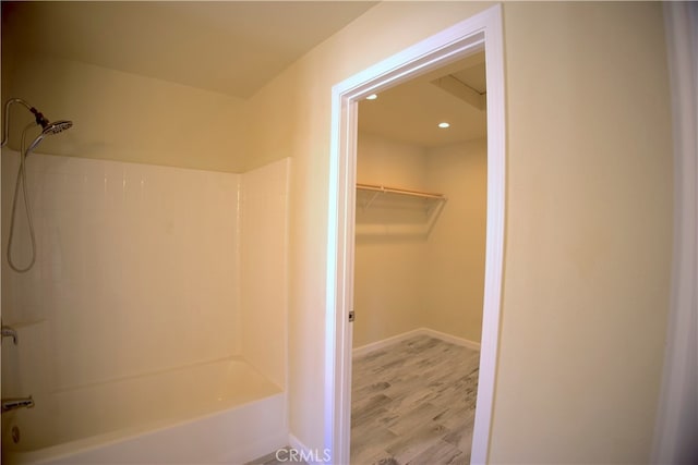 bathroom featuring hardwood / wood-style flooring and tub / shower combination