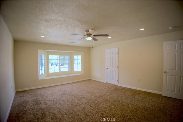 carpeted empty room featuring a textured ceiling and ceiling fan