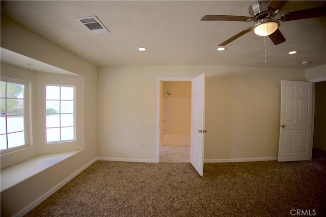 carpeted empty room with a textured ceiling and ceiling fan