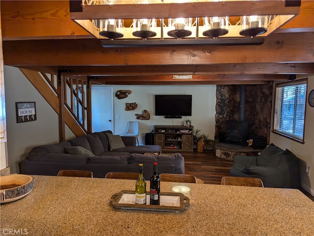 living room with a wood stove and wood-type flooring