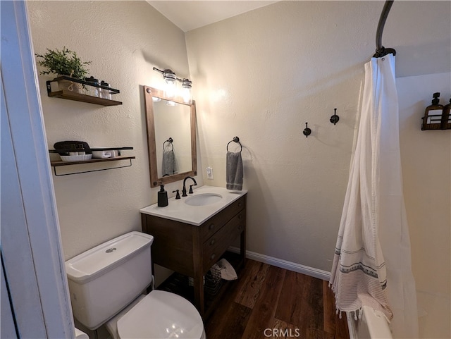 bathroom with vanity, wood-type flooring, and toilet